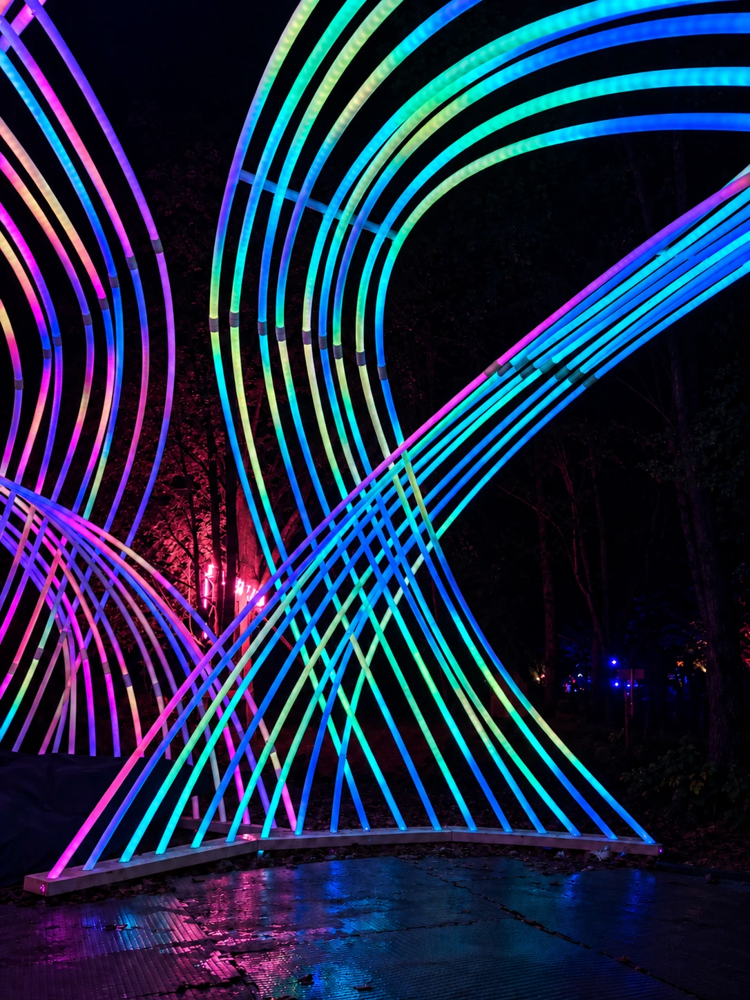 Cyan and violet ribs sweep around an opening inside Kagora, with pink light behind the curved layers.