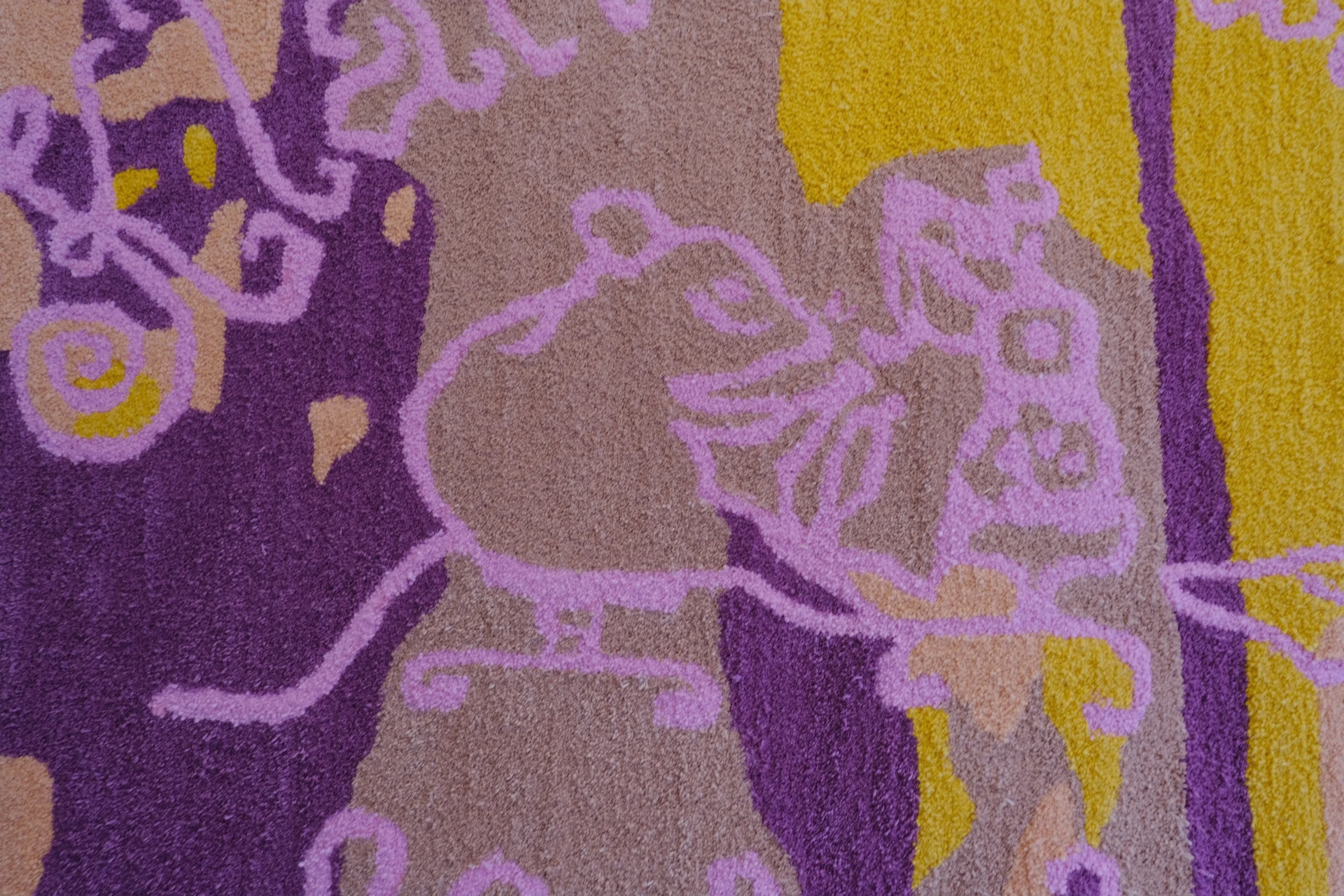 The pink outline of Klättermusen's sewing mouse is drawn in tufted wool over the botanical pattern.